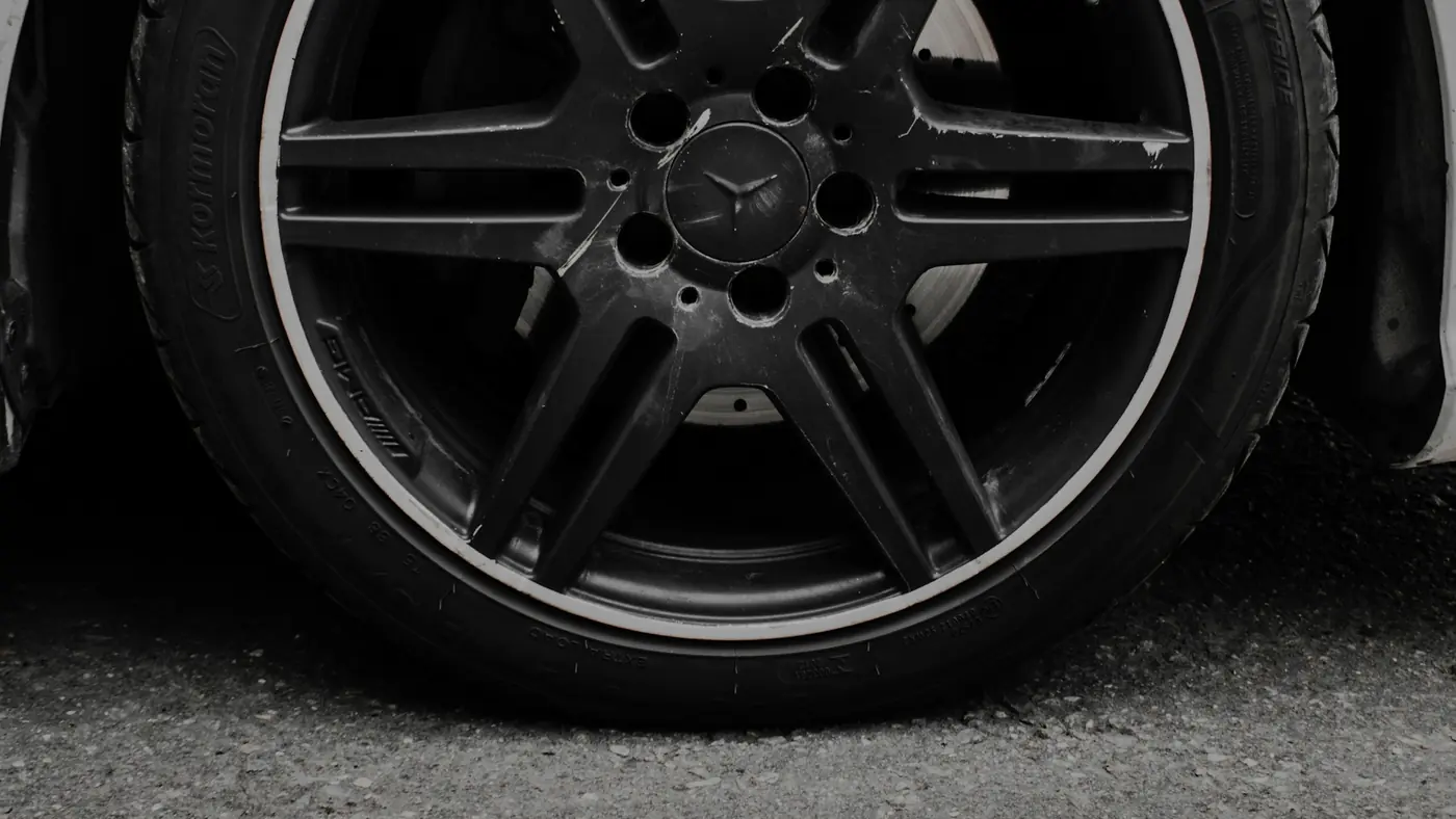 A clean alloy wheel and tyre on tarmac.
